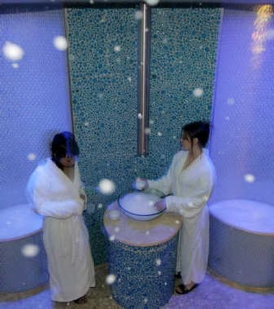 
Two models play in fake snow descending from the ceiling in Qua's Arctic Ice Room at Caesars Palace hotel-casino in Las Vegas. Some people come to Las Vegas to enjoy the clear skies and warm days, but a new spa at Caesars has a treatment room where it snows all year long.
 (Associated Press / The Spokesman-Review)