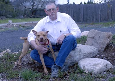 Dan Storie has turned his passion for pets into a service organization, Community Pets, dedicated to educating owners on spaying, neutering and caring for their animals. He sits with Buddy, who was abandoned and adopted four times through SCRAPS.  (J. BART RAYNIAK / The Spokesman-Review)