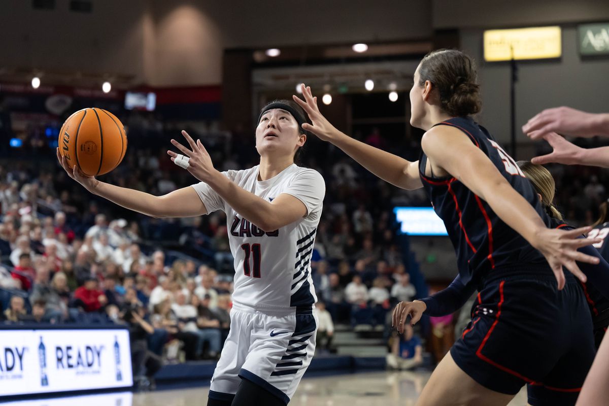 Gonzaga guard Kayleigh Truong (11) eyes the basket as Pepperdine forward Megan Harkey (31) defends during the first half of a NCAA college basketball game, Thursday, Feb. 8, 2024, in the McCarthey Athletic Center.  (COLIN MULVANY)