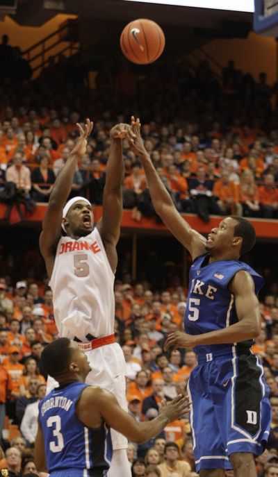 Syracuse’s C.J. Fair shoots over Duke’s Tyler Thornton, bottom left, and Rodney Hood, right. (Associated Press)