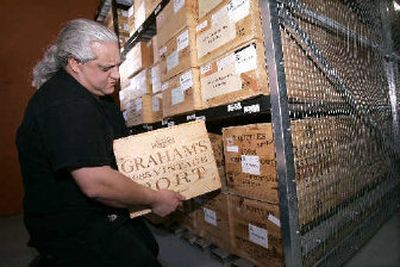 
Shaul Shemesh, operations manager of Guarantee Wine Storage, pulls out a case of port being stored for clients at the company's temperature- controlled warehouse in Jersey City, N.J. 
 (Associated Press / The Spokesman-Review)