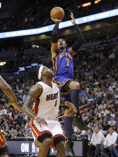 New York's Carmelo Anthony (7) shoots over Miami Heat's LeBron James (6). Anthony scored 29 points in the Knicks’ win. (Associated Press)