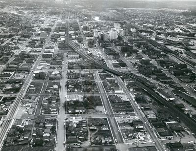 Early 1960s - In this aerial photo looking west over downtown Spokane, Washington, the Northern Pacific tracks winds from lower right, past the NP depot at 1st Ave. and Bernard St., and west down Railroad Ave. The NP line, connected in 1883, was the first transcontinental railroad through Spokane. As Interstate 90 was finished and Expo 74 construction was underway, the railroad companies agreed to put all rail traffic on the original NP corridor. (SPOKESMAN-REVIEW PHOTO ARCHIVE / SR)