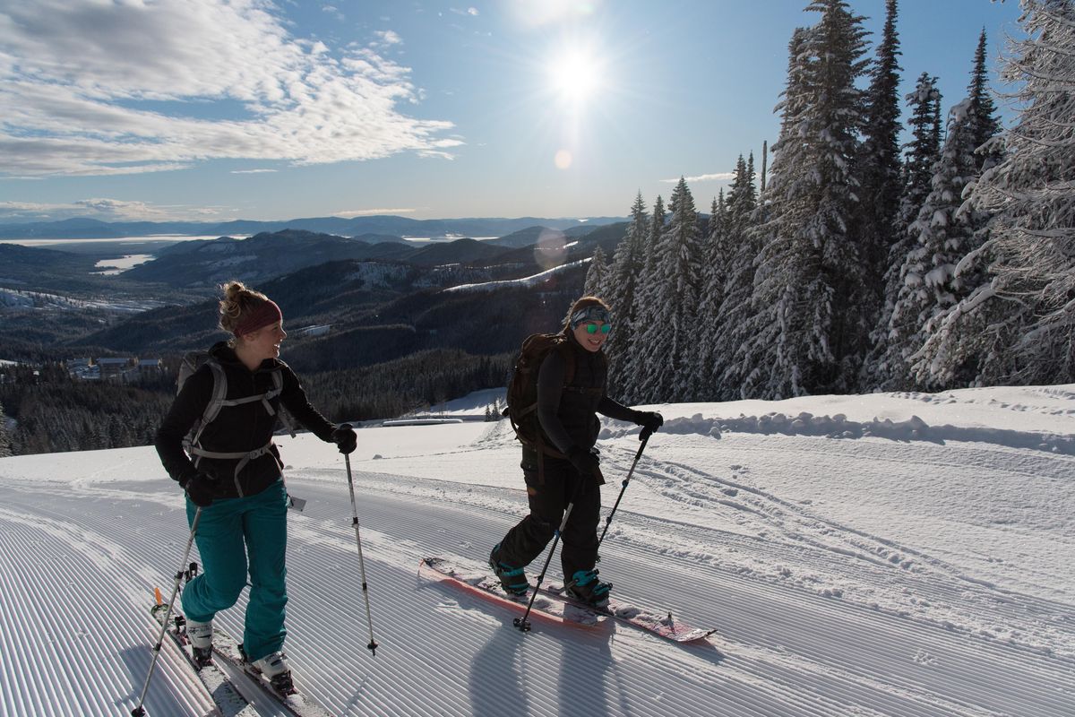 Carolyn Cartwright (left) and Sara Dunbar skin up Mount Spokane before work on Saturday, March 3, 2018. (Eli Francovich / The Spokesman-Review)