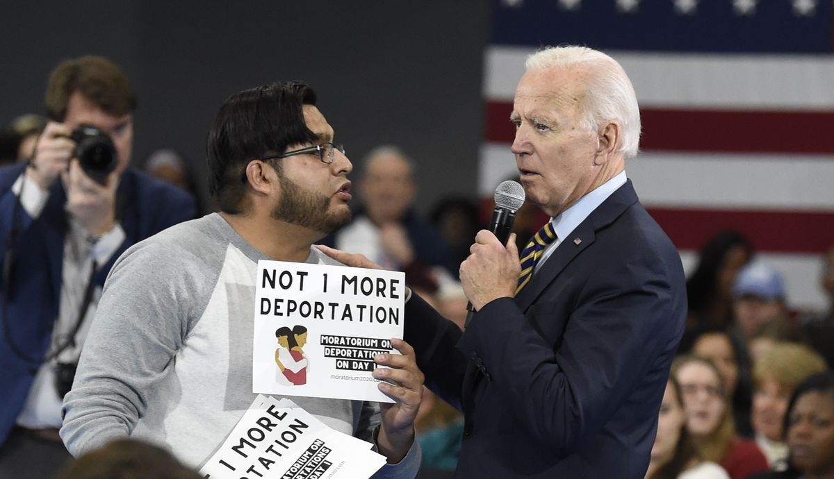 Democratic presidential hopeful Joe Biden talks with a protester objecting to his stance on deportations during a town hall at Lander University in Greenwood, S.C., on Thursday, Nov. 21, 2019. President Joe Biden