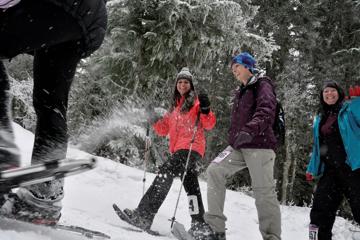 From left, Kristina Kripaitis, Jamie Jordan and Melody Jamieson add a splash of color to the snow shower on the trails at Mount Spokane during the 10th annual Women