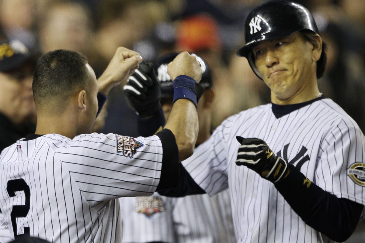 Derek Jeter, left, congratulates Hideki Matsui on his sixth-inning homer. (Associated Press / The Spokesman-Review)