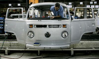 An auto worker installs the dash panel of a Silver Edition Volkswagen van at the company's factory in Sao Bernardo do Campo, Brazil, last week. The company is being forced to change from air-cooled engine models because of a new Brazilian law to reduce pollution that goes into effect in 2006.
(Associated Press / The Spokesman-Review)