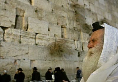 
Jews on Thursday pray at the Western Wall, Judaism holiest site, in Jerusalem. Rabbis called on Israelis to flock to synagogues and say special prayers for 77-year-old Israeli Prime Minister Ariel Sharon who fought for his life Thursday following seven hours of emergency surgery to stop widespread bleeding in his brain. 
 (Associated Press / The Spokesman-Review)