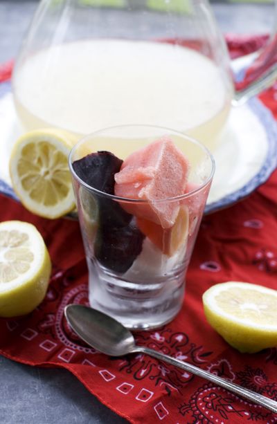 Patriotic lemonade, garnished with ice cubes made with watermelon, coconut milk and blueberries, makes a colorful holiday beverage. (Associated Press)