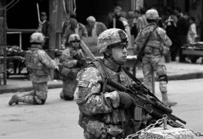 
A U.S.  soldier stands guard as his unit patrols central Baghdad, Iraq, on Thursday. 
 (Associated Press / The Spokesman-Review)