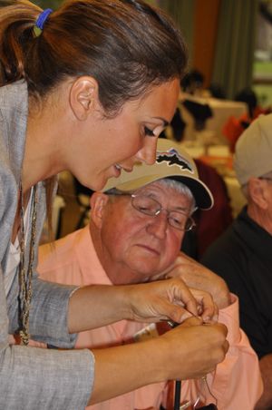April Vokey, a British Columbia fly fishing guide and founder of Fly Gals Ventures, shows fly tying techniques to Neal Beechinor of the Inland Empire Fly Fishing Club.  (Rich Landers)