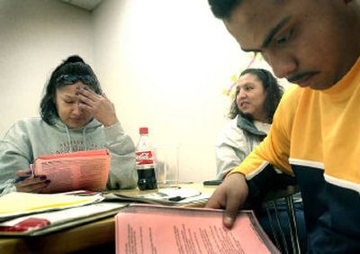 
Terri Little Light, center, asks a question as her sister Rosella Bulltail, left, and Saul Mendoza read along in a recent class.  The sisters came from Lodge Grass, Mont., and Mendoza came from Mattawa, Wash., to take part in the high school equivalency crash course. 
 (Joe Barrentine / The Spokesman-Review)