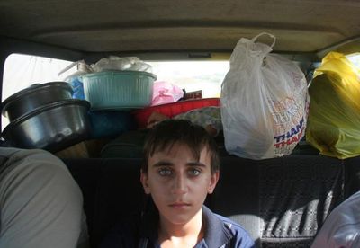 A Christian boy sits in the back of his family’s car after leaving Mosul,  Iraq, on Monday.  (Associated Press / The Spokesman-Review)
