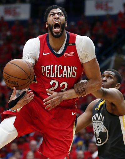 New Orleans Pelicans forward Anthony Davis is fouled as he drives to the basket against Golden State in Game 3 of the Western Conference semifinal series Friday night in New Orleans. (Gerald Herbert / Associated Press)