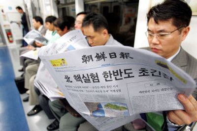 
Subway passengers in Seoul read news of North Korea's nuclear test today. 
 (Associated Press / The Spokesman-Review)