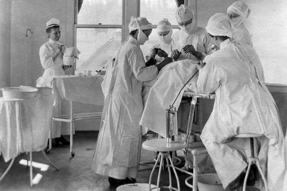 Nurses and doctors perform their duties in a Deaconess surgical suite in 1917.
