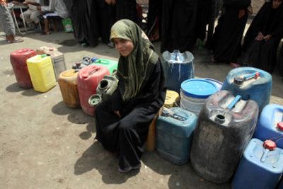 
An Iraqi girl waits in line for fuel in Baghdad on Monday. 
 (Associated Press / The Spokesman-Review)