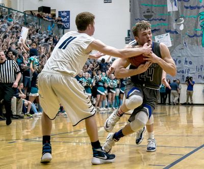 Coeur d’Alene's Joey Naccarato, right, fights his way to the hoop against Lake City’s Duncan Butler last Friday night at Lake CIty High School. (BRUCE TWITCHELL/Special to The S / Bruce Twitchell Special to The Spokesman-Review)