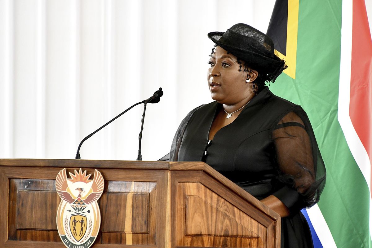 In this photo provided by the South African Government Communications and Information Services (GCIS), premier of the Mpumalanga province Refilwe Mtsweni-Tsipane addresses mourners, Sunday, Jan. 24, 2021, at the funeral of Cabinet minister Jackson Mthembu, who died of COVID-19 last week. Police are investigating Refilwe Mtsweni-Tsipane for failing to wear a mask and hugging a police officer at the public funeral.  (Kopano Tlape)
