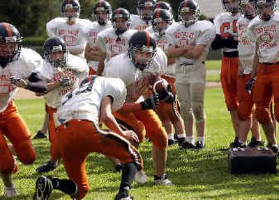 
The West Valley High football players run a drill during an after-school practice. West Valley High is waiting to see if its sports teams will be reclassified in the WIAA. 
 (Liz Kishimoto / The Spokesman-Review)