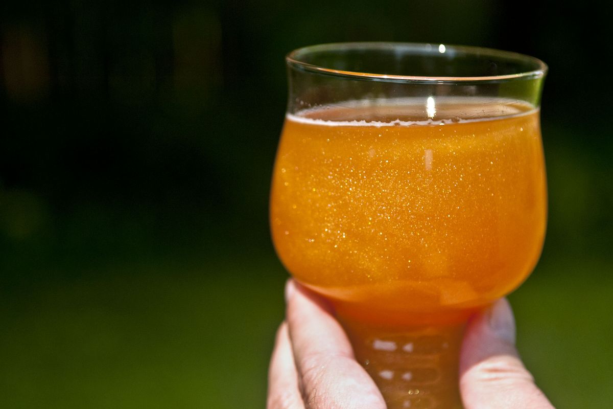Mark and Courtney Haney’s Infinite Glitter Cider, a 2018 brew at Bardic Brewing and Cider taproom at the Sullivan Square Shopping Center in Spokane Valley, gives off a golden glow.  (Kathy Plonka/THE SPOKESMAN-REVIEW)