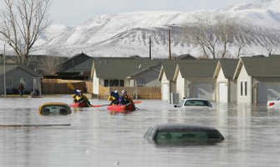 
Reno rescue team members search a neighborhood in Fernley, Nev., on Saturday after a canal levee ruptured from heavy rainfall. Associated Press
 (Associated Press / The Spokesman-Review)