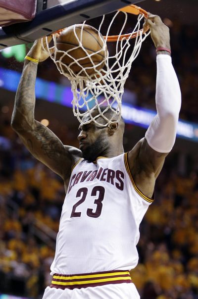 LeBron James dunks for 2 of his 23 points in game 5 Wednesday. (Tony Dejak / Associated Press)