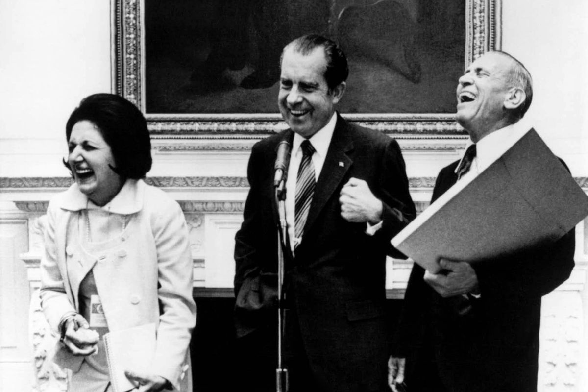September 1971: President Richard Nixon laughs with UPI reporter Thomas, left, and AP reporter Douglas Cornell during an impromptu reception in Washington.