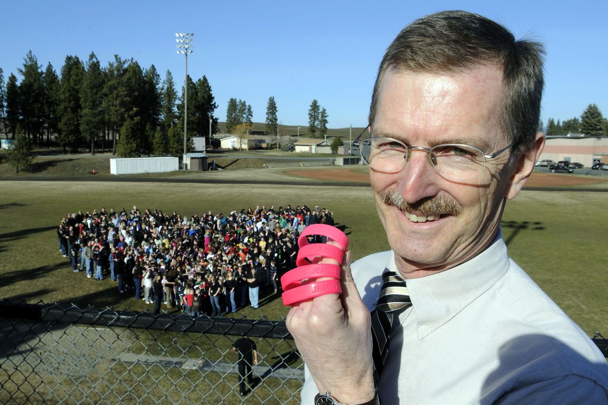 Liberty School District superintendent Bill Motsenbocker stands in front of the entire student body, teachers, staff and bus drivers in the district, who gathered in the shape of a heart on a football field near Spangle on Monday Feb. 22, 2010. The group was showing support for Motenbocker