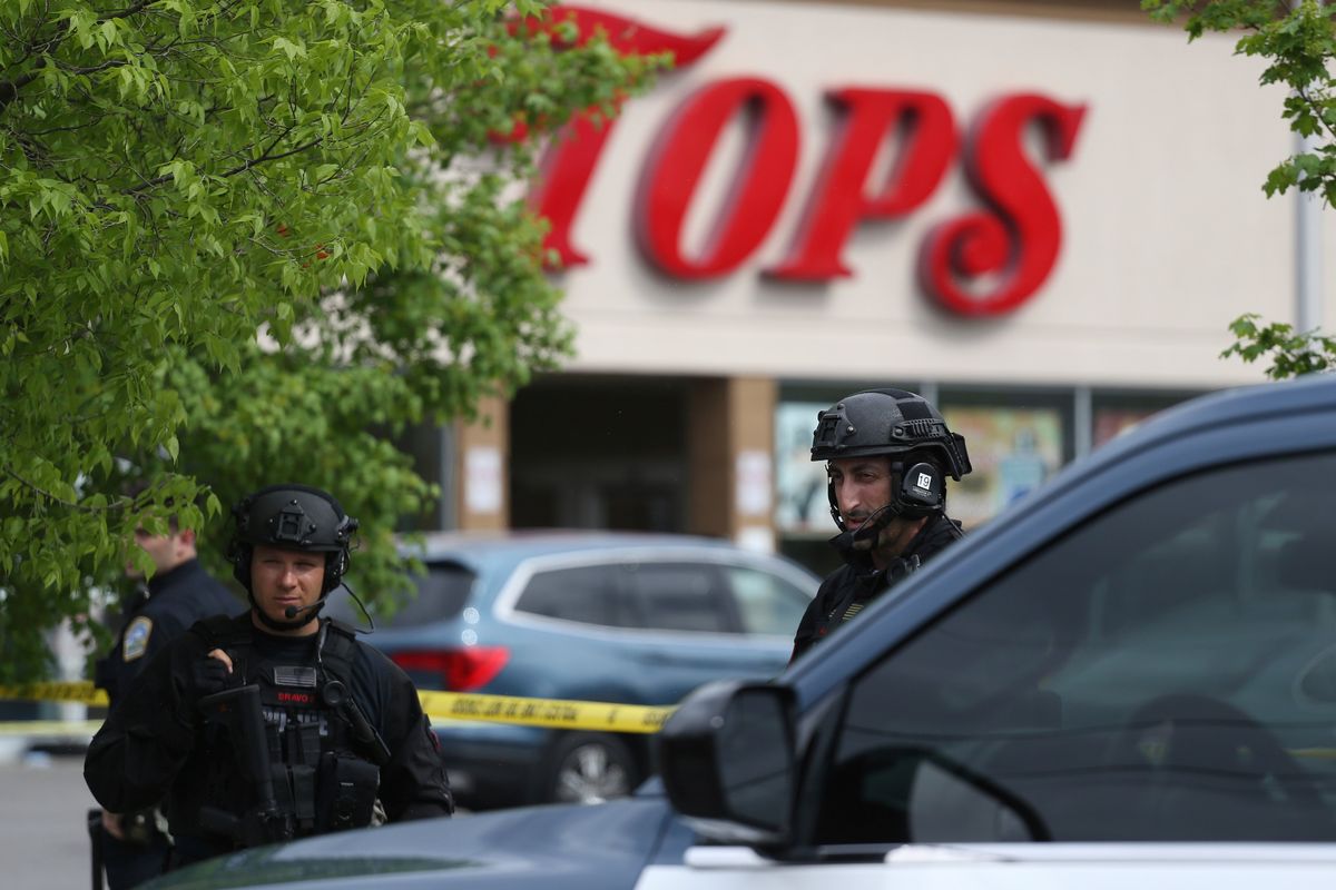 Police secure a perimeter after a shooting at a supermarket, Saturday, May 14, 2022, in Buffalo, N.Y.  (Joshua Bessex)
