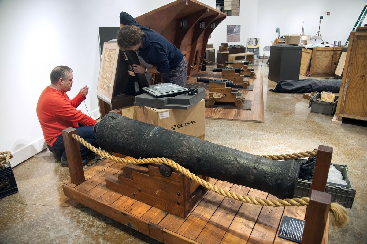 John Moredo-Burich, left, and Chris Wirkkala assemble the Treasure! exhibit at the Northwest Museum of Arts and Culture, Jan. 15, 2016. The 1,000-pound cannon is from a 1812 shipwreck of the brig Adams, renamed Detroit and was salvaged in 1963. (Dan Pelle / The Spokesman-Review)