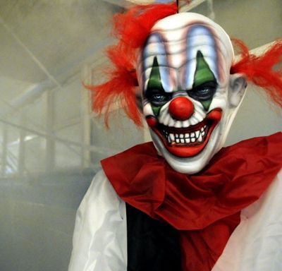 In this 2008 SR file photo, an evil clown and other scary creatures await visitors to the Cheney Haunted House located at the Cheney Pool. J.P. Russo hangs spider webs in the hallway behind the clown. Dan Pelle/SR file photo)