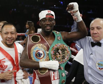 In this Dec. 10, 2016, file photo, Terence Crawford is declared winner over John Molina Jr. after a WBO junior welterweight boxing bout in Omaha, Neb. Crawford is set to fight on one of its biggest stages. The undefeated 140-pound champion defends his titles Saturday at Madison Square Garden against 2008 Olympic gold medalist Felix Diaz, who could be backed by a big crowd of Dominican supporters. (Nati Harnik / Associated Press)