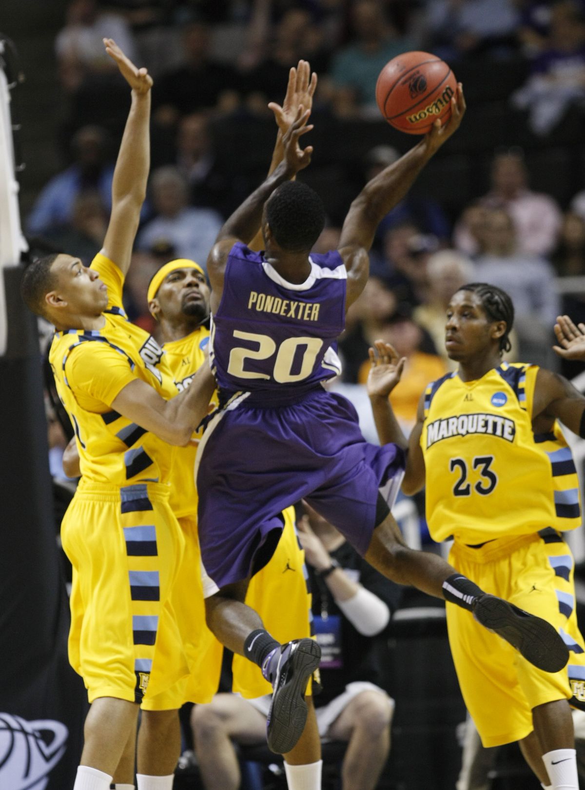 UW’s Quincy Pondexter drives against, left to right, Joseph Fulce, Lazar Hayward and Dwight Buycks.  (Associated Press)