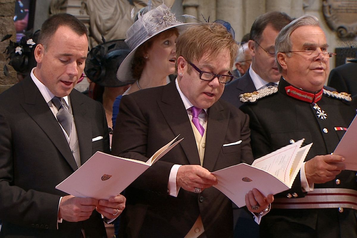 In this image taken from video, British singer Elton John, center, and his partner David Furnish, left, sing during the ceremony at Westminster Abbey for the Royal Wedding in London on Friday, April, 29, 2011. (AP Photo/APTN)