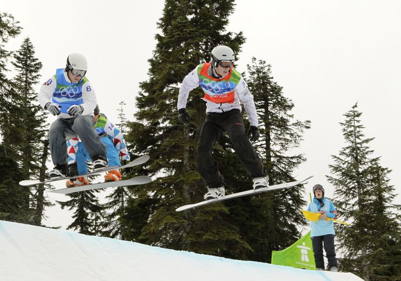 Mike Robertson of Canada, right, leads, Nate Holland of the USA, left during the snowboard cross final at the Vancouver 2010 Olympics in Vancouver, British Columbia, Monday, Feb. 15, 2010. (Jae Hong / Associated Press)