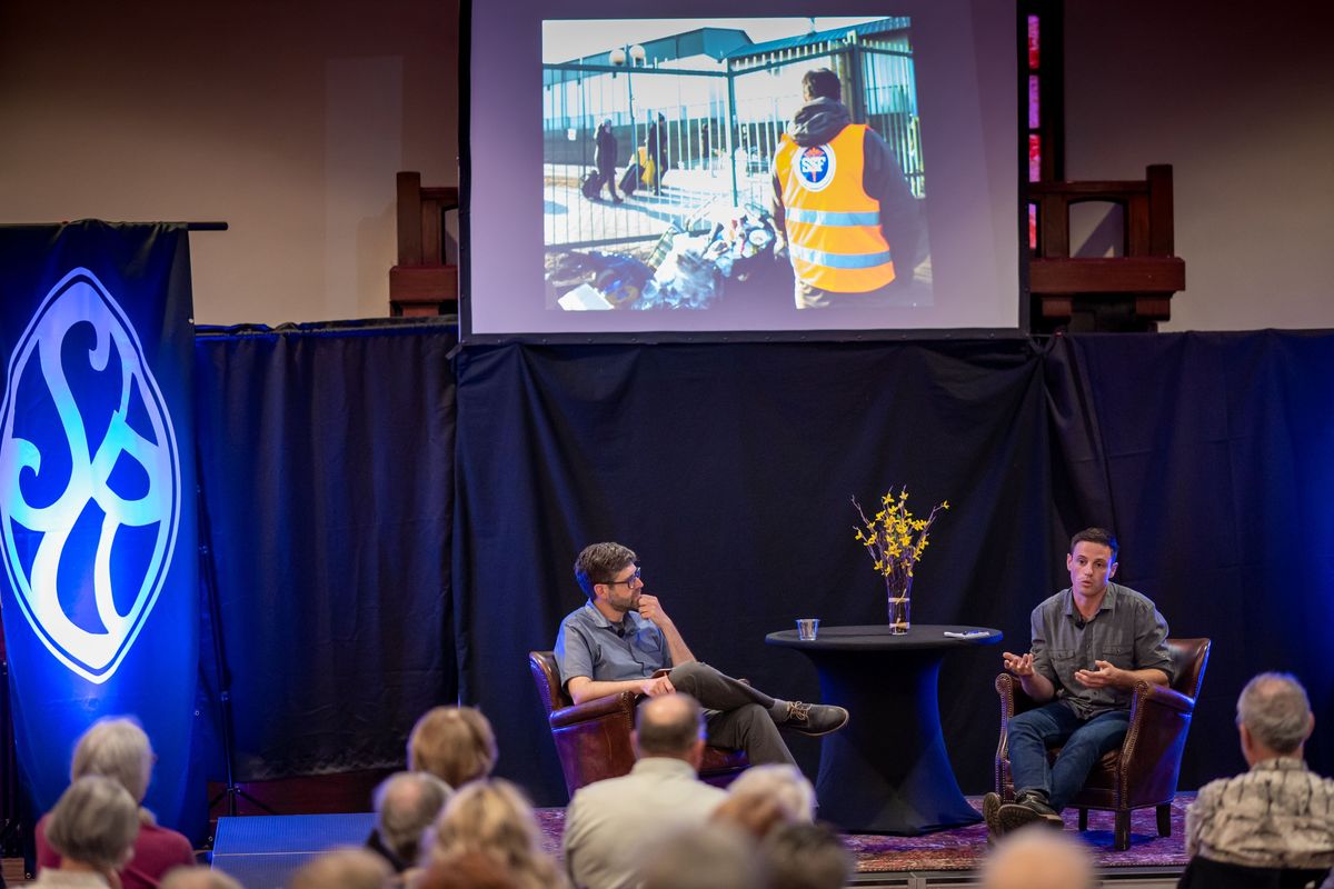 During a conversation with Assistant Managing Editor Jonathan Brunt, on left, Spokesman-Review reporter Eli Francovich, who recently returned from assignment in Ukraine and Poland, discusses what he saw, and shares stories and photographs that didn't make the paper, Tuesday. June 21, 2022, during a Northwest Passages event held at the Montvale Event Center.  (COLIN MULVANY/THE SPOKESMAN-REVIEW)