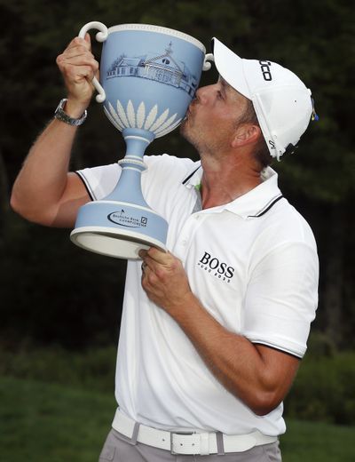 Henrik Stenson of Sweden has a kiss for the trophy after winning the Deutsche Bank. (Associated Press)