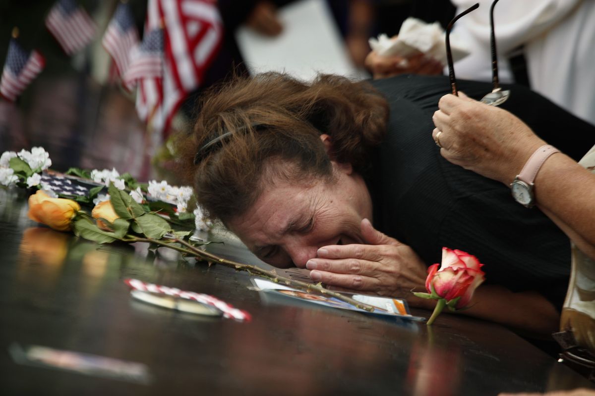 A woman at the 9/11 memorial in New York on Sunday mourns the loss of her son during the World Trade Center attacks 10 years ago. (Associated Press)