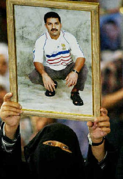 
A Palestinian woman attends a Gaza City rally on Sunday with a picture of a relative being held in an Israeli jail. 
 (Associated Press / The Spokesman-Review)
