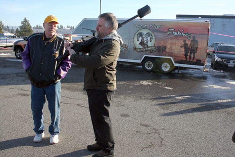 Dale Heimbigner of Coeur d'Alene carries an ArmaLite AR-50 at the Second Amendment rally outside Black Sheep Sporting Goods on Saturday. (Alecia Warren/press)