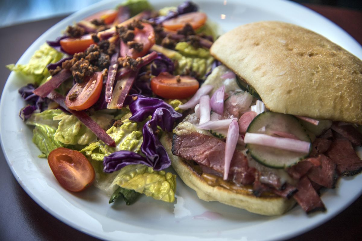 The pastrami sandwich from Wiley’s Downtown Cafe includes swiss cheese, house pickled root veggies, caraway seeds, sweet hot mustard and torta.  The sandwichis shown with  a chopped bacon cabbage, heirloom carrot, tomato romaine, gorgonzola vinaigrette salad. Dan Pelle/THE SPOKESMAN-REVIEW (Dan Pelle / The Spokesman-Review)
