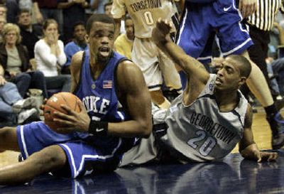 
Duke's Sheldon Williams looks to pass after corralling a loose ball against Georgetown's Darrel Owens on Saturday. 
 (Associated Press / The Spokesman-Review)