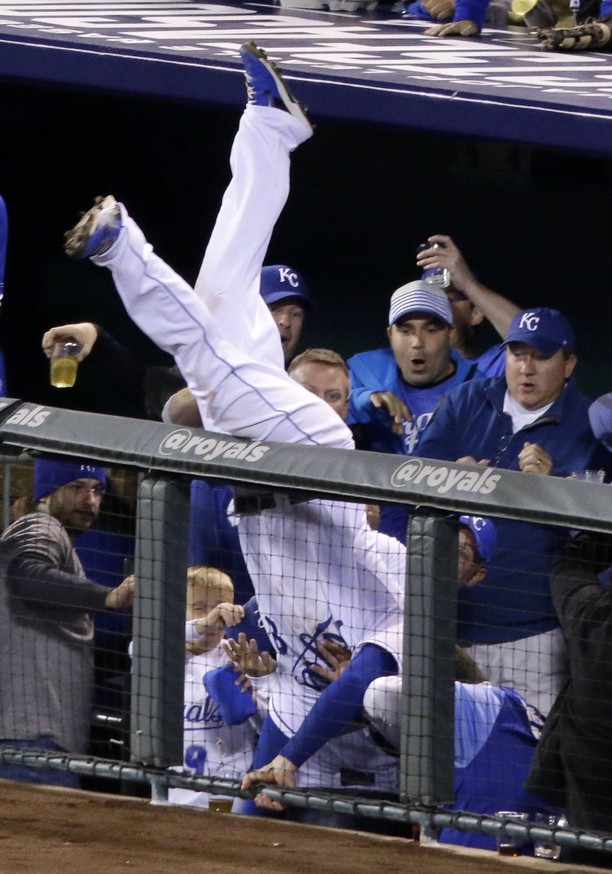 Royals third baseman Mike Moustakas makes catch at railing. (Associated Press)