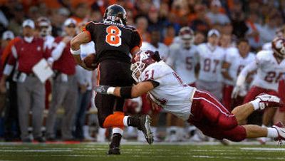 
WSU linebacker Will Derting dives to sack Oregon State quarterback Matt Moore. Derting couldn't hold on, and Moore threw a 63-yard touchdown pass to Mike Hass to seal the Beavers' victory. 
 (Christopher Anderson/ / The Spokesman-Review)