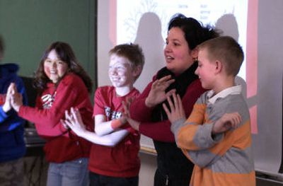 
Kathy Ward, an author, recreational therapist and psychologist, and students Lance Godfrey, second from left, and Tristan Dale, right, explain to George Gessler's East Farms Elementary fourth-grade class how neurons work together in the brain. Ward came to East Farms  as a part of Brain Awareness Week.
 (J .BART RAYNIAK / The Spokesman-Review)