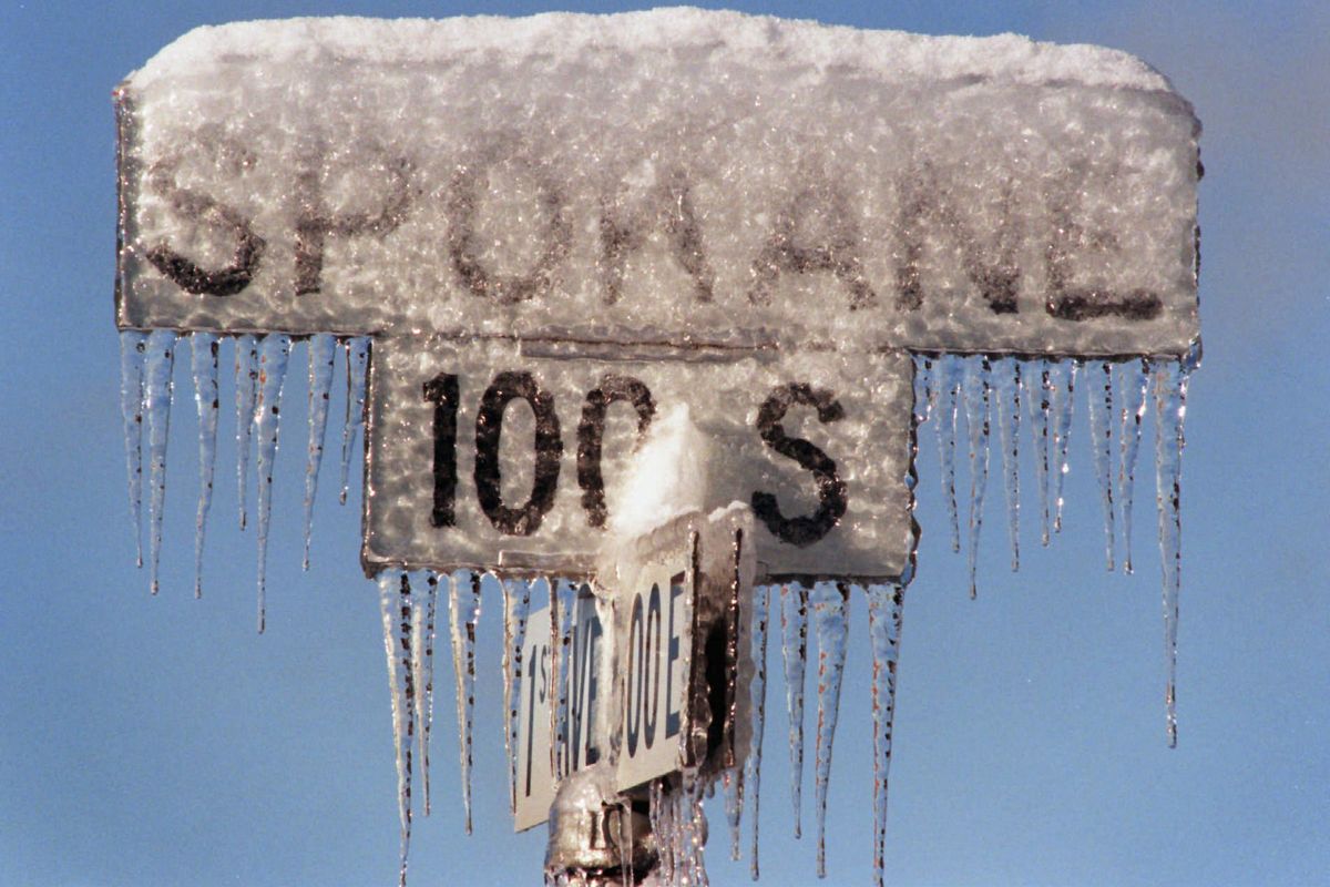A street sign says it all about the Nov. 19, 1996, ice storm that hit Spokane. Many folks were without power, everywhere were scenes like this sign appears, with frozen snow and ice hanging everywhere. (Christopher Anderson/The Spokesman-Review)