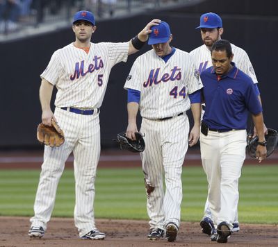 Mets’ David Wright, left, gives encouragement to teammate Jason Bay after Bay was injured on Friday. (Associated Press)