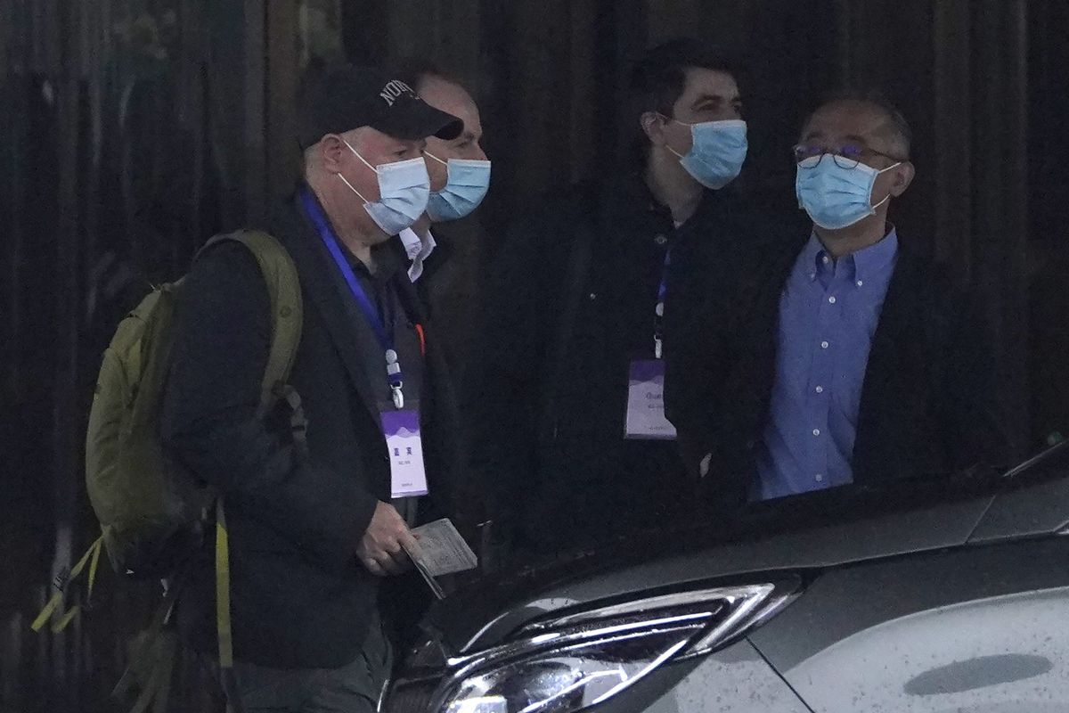 Members of the World Health Organization team including Peter Daszak, left, Ken Maeda, right, and Vladimir Dedkov, second right, prepare to leave for a fourth day of field visits from their hotel in Wuhan in central China